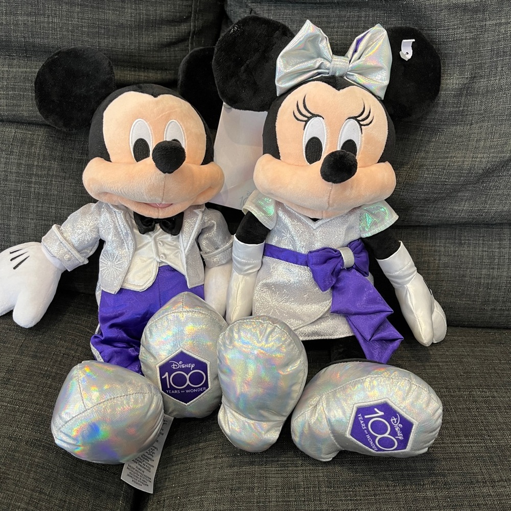 Mickey and Minnie Mouse plush with Disney100 outfit.
